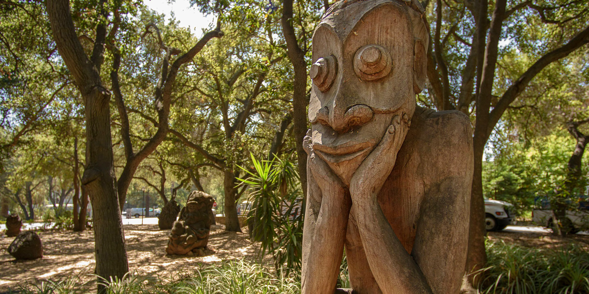 Sculpture face resting in hands in the Papua New Guinea Sculpture garden